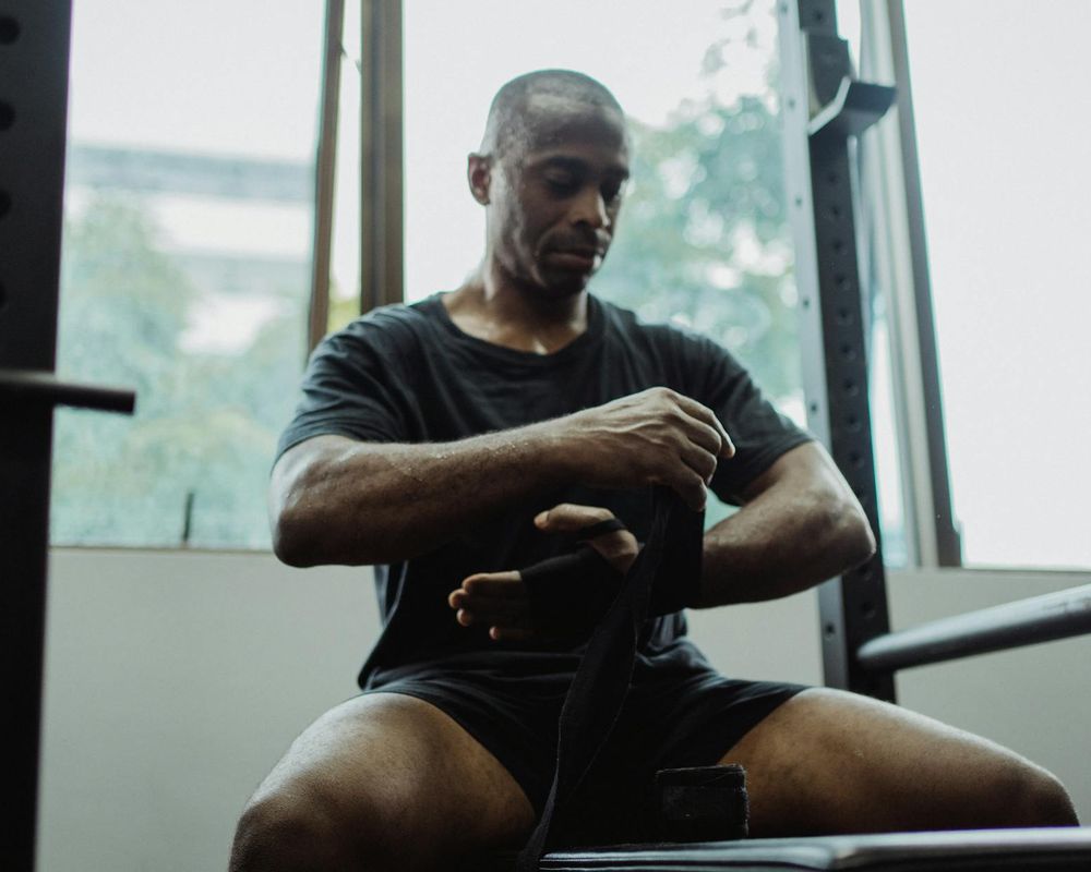 Close up of sports equipment and a man preparing for workout