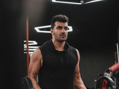 Man hands holding weights during a strength exercise session