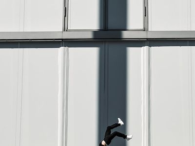 Shadow of a man performing balance exercises on wall